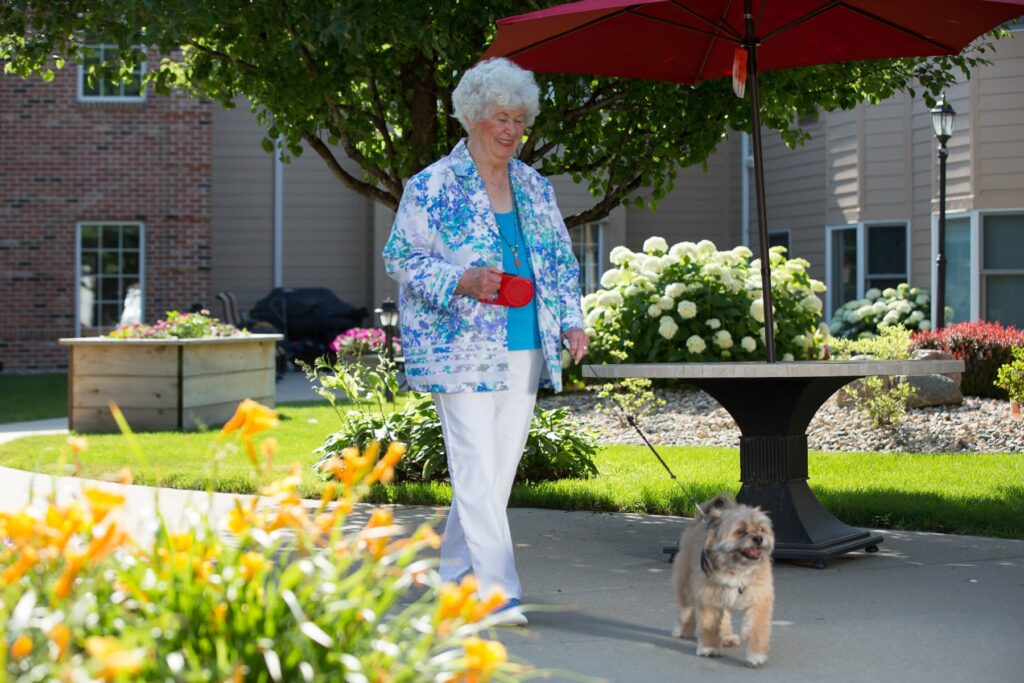 lady walking dog in courtyard