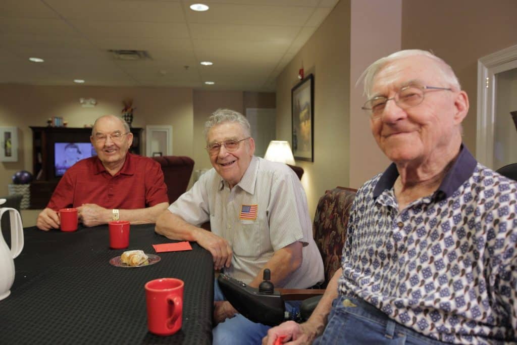 Residents Smiling With Coffee And Pastry