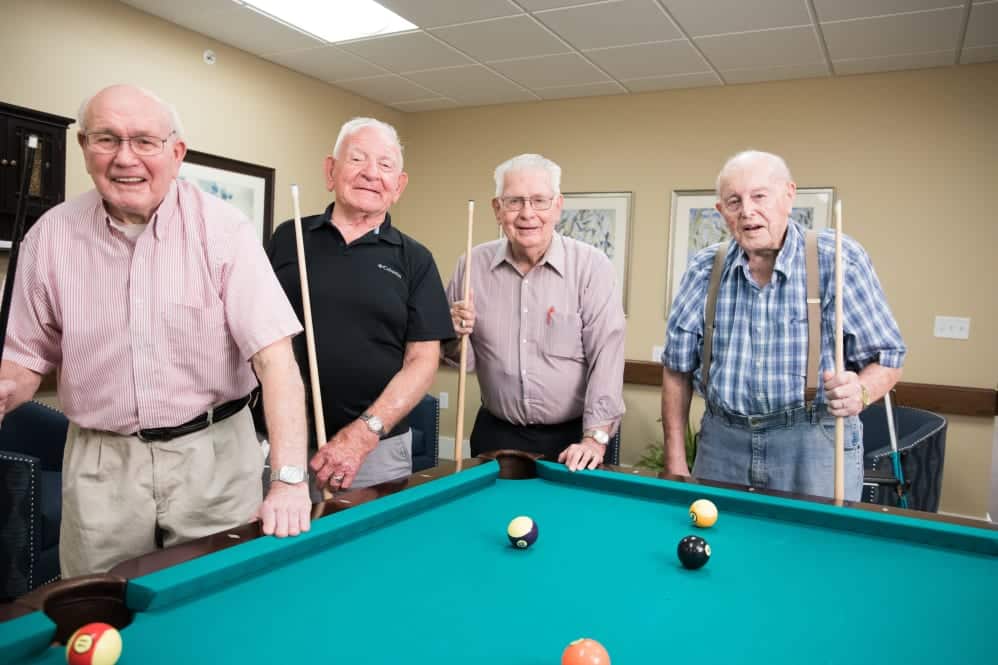 Residents Smiling At Pool Table