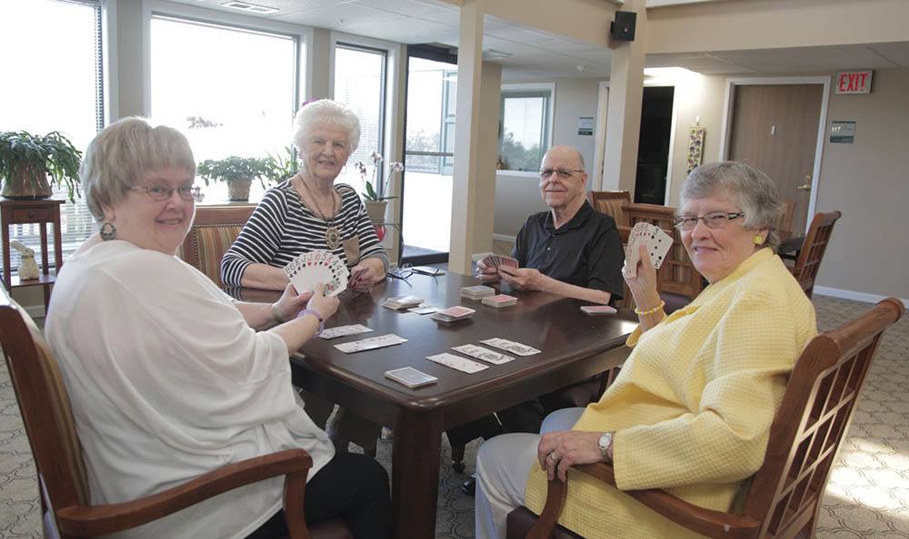 Residents Playing Game At Table