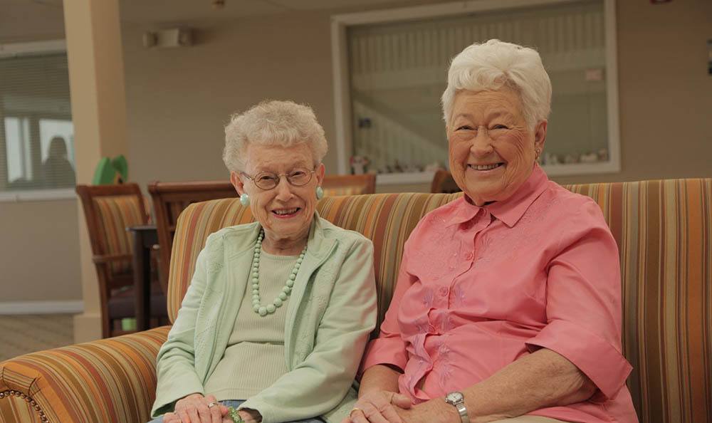 Residents Smiling On Couch