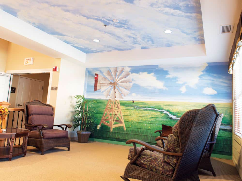 Residents Lounge Area With Chairs And Mural