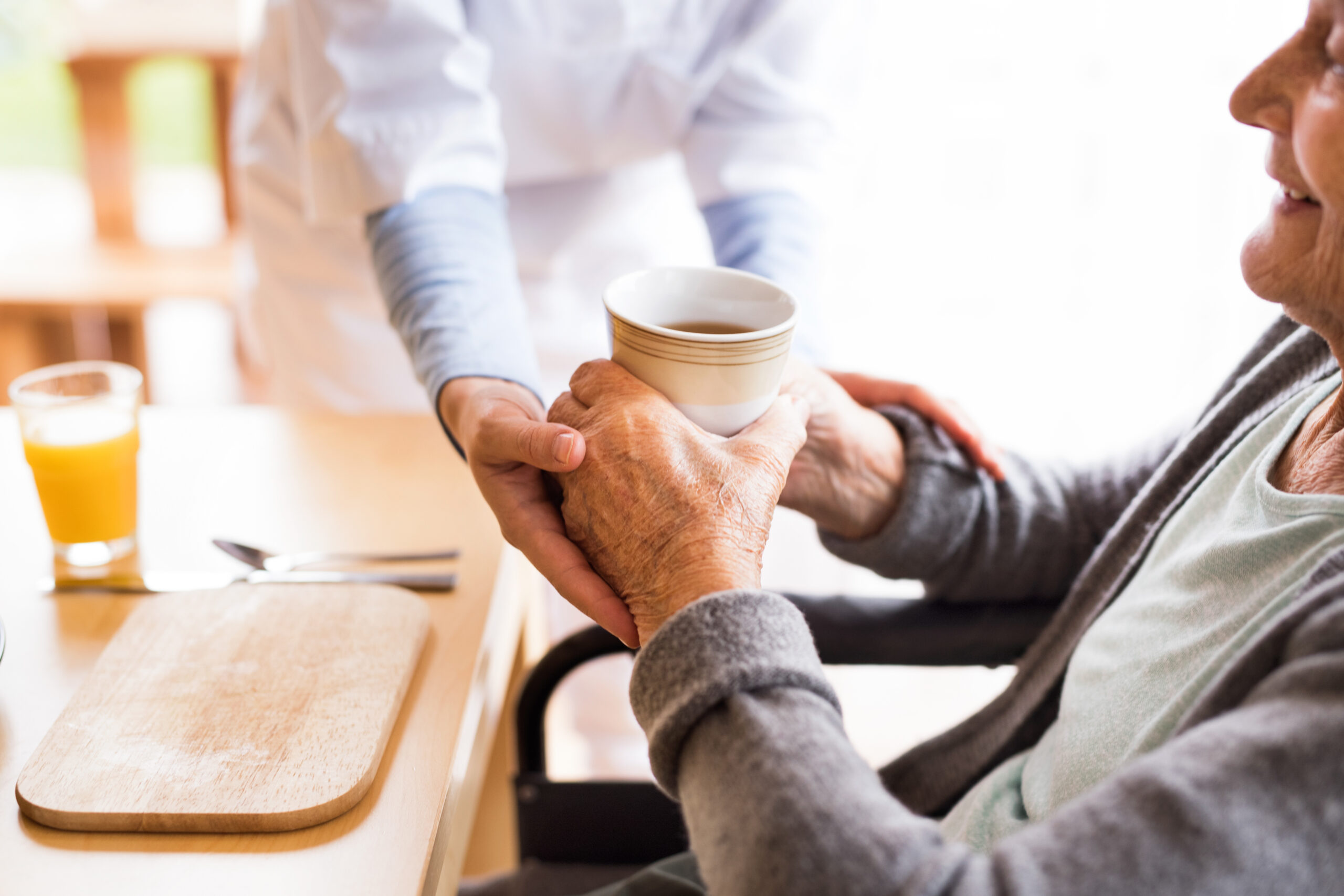 elderly man being served coffee