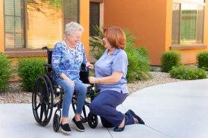Caregiver Helping A Respite Care Resident