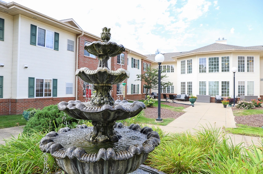 The outdoor fountain with water trickling down in a garden at The Heritage at Northern Hills