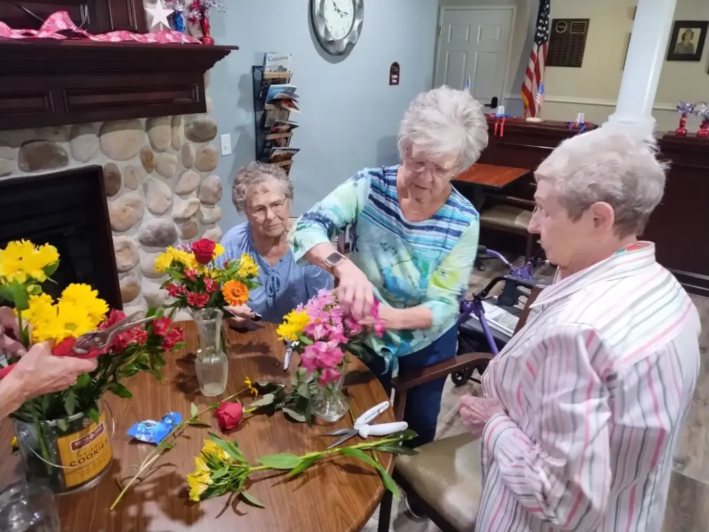 A group of senior women creating bouquets of flowers at The Heritage at Fox Run