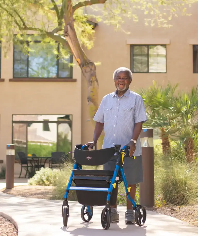 A man with walker outside Orchard Pointe at Surprise senior living community