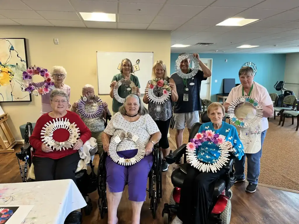 Seniors from Orchard Pointe at Arrowhead retirement community show off their crafts